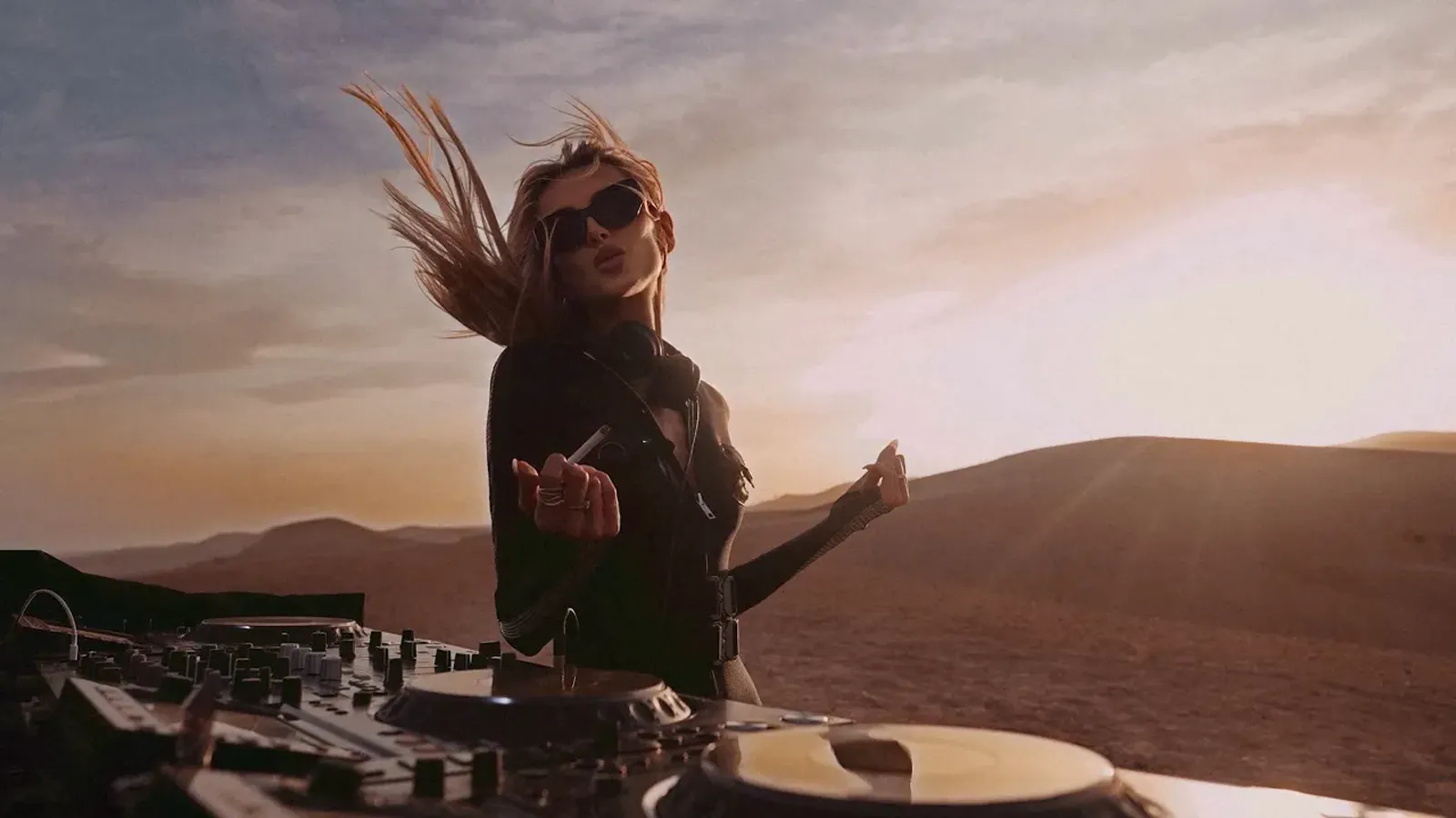 DJ performing a sunset set in the desert, filmed for a music video
